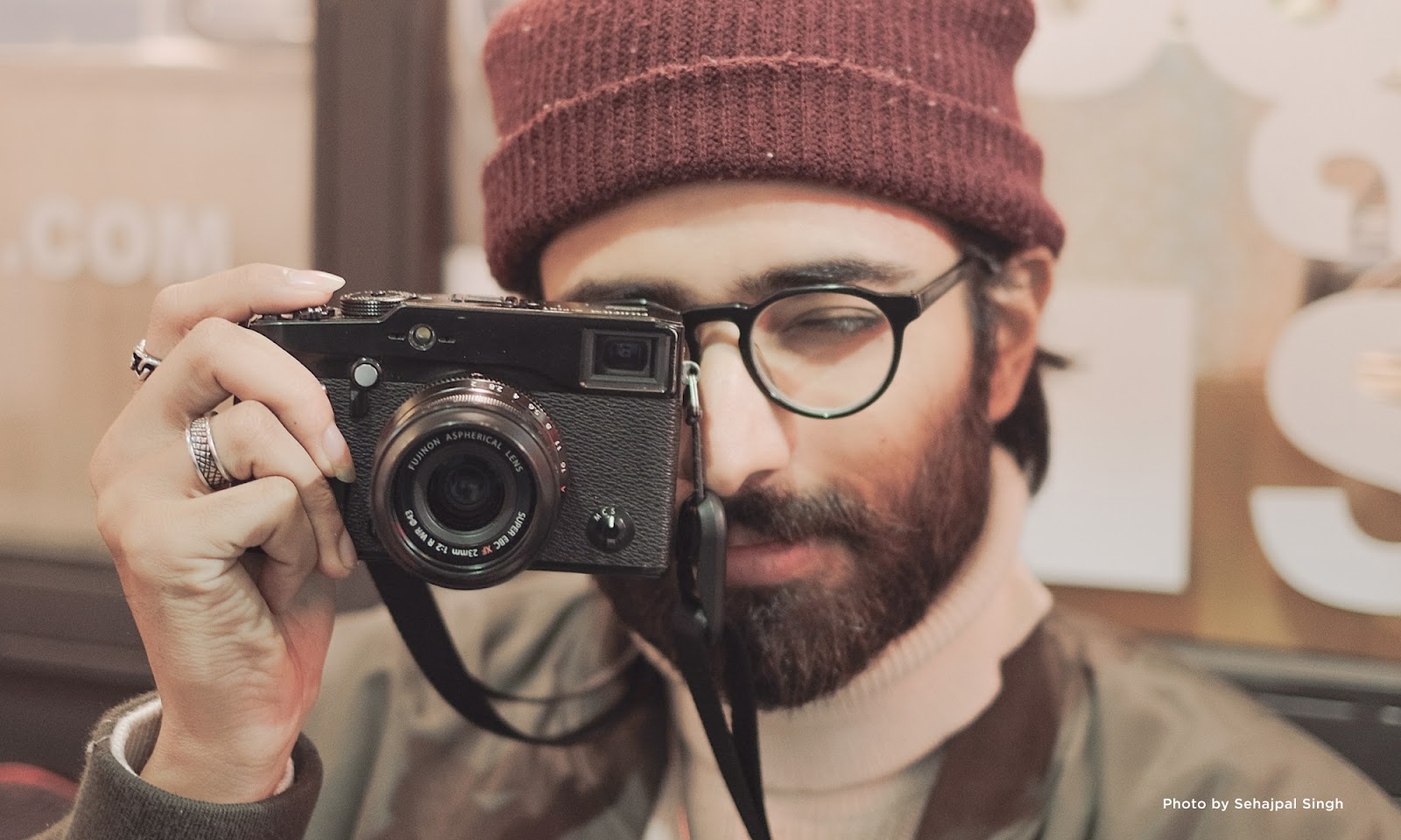 Close-up of a man holding a camera.
